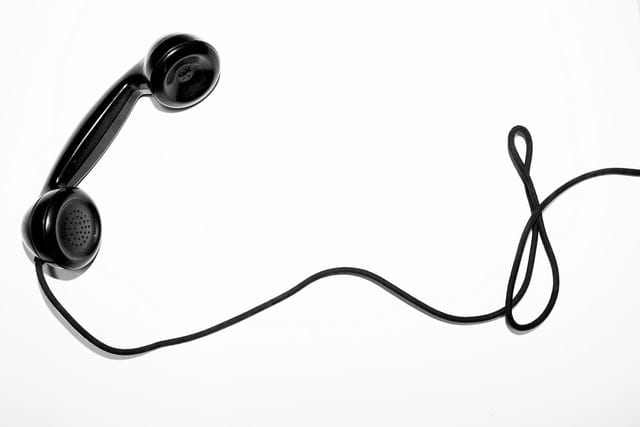 image of a black phone with a long phone cord